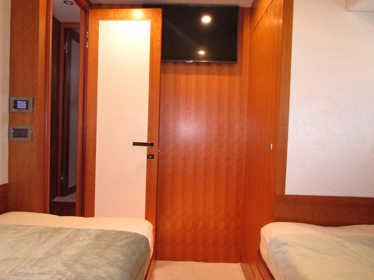 a room with a bed and a door aboard JOHNSON 83 SKYLOUNGE Yacht for Sale