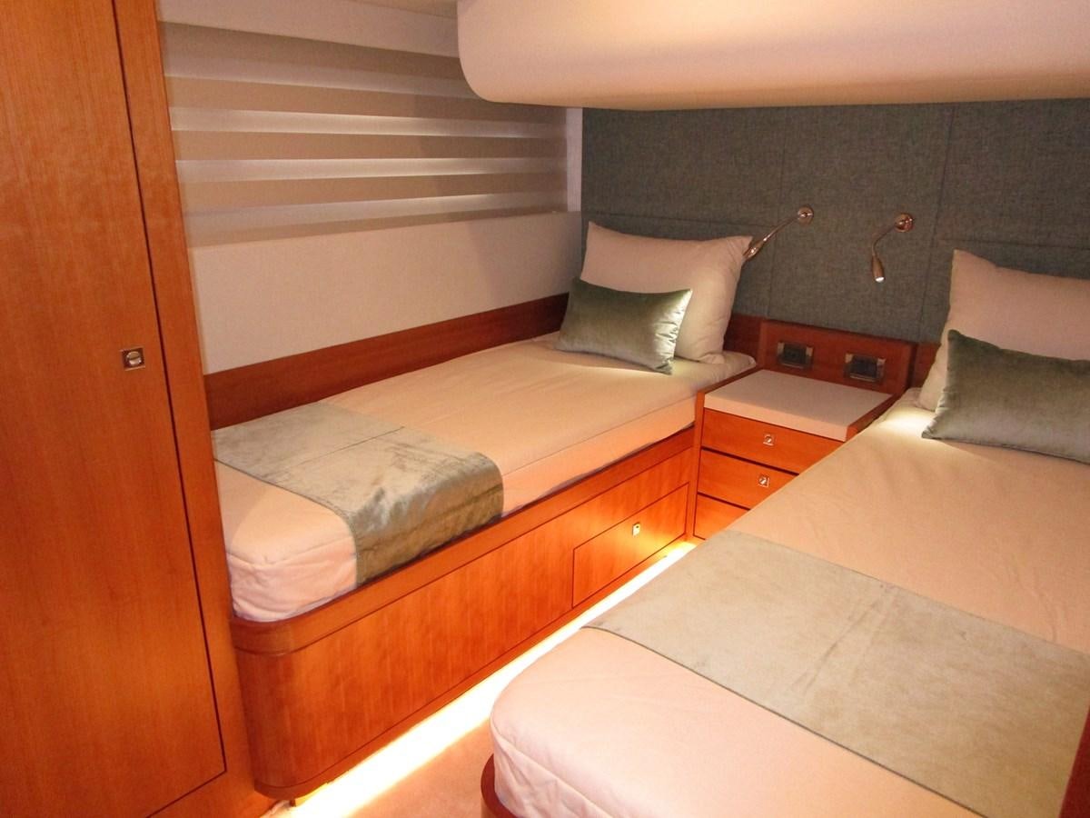a room with two beds aboard JOHNSON 83 SKYLOUNGE Yacht for Sale