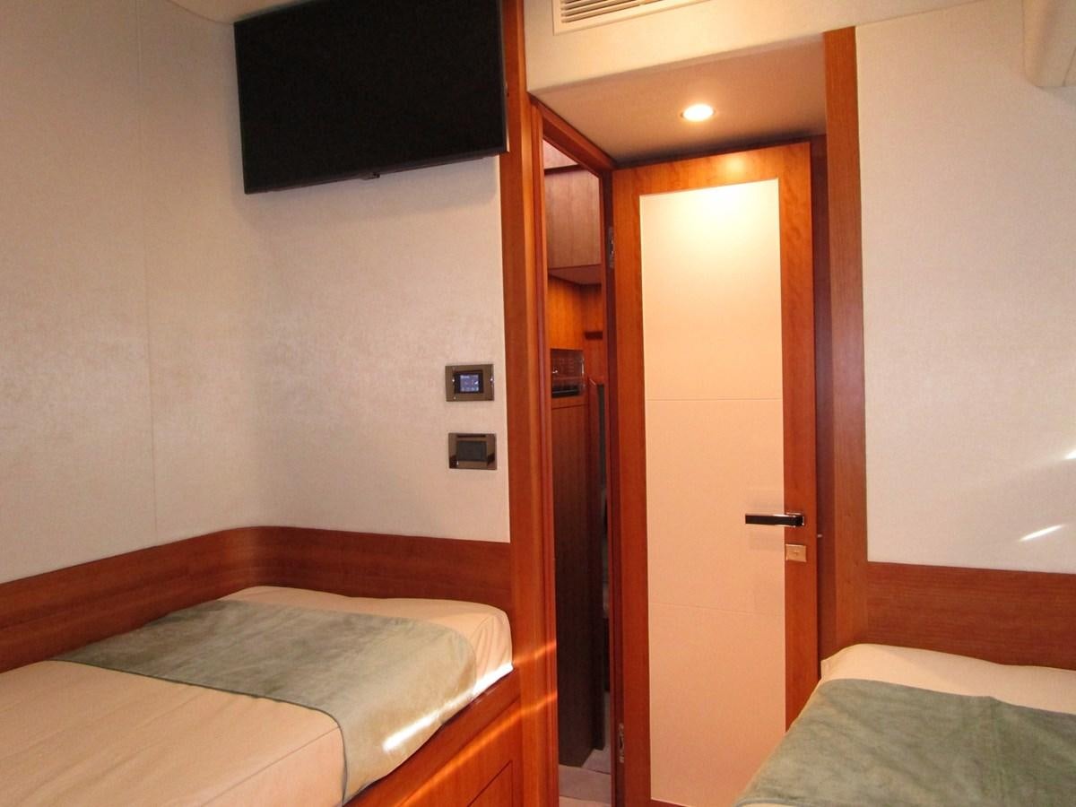 a bedroom with a bed and a closet aboard JOHNSON 83 SKYLOUNGE Yacht for Sale