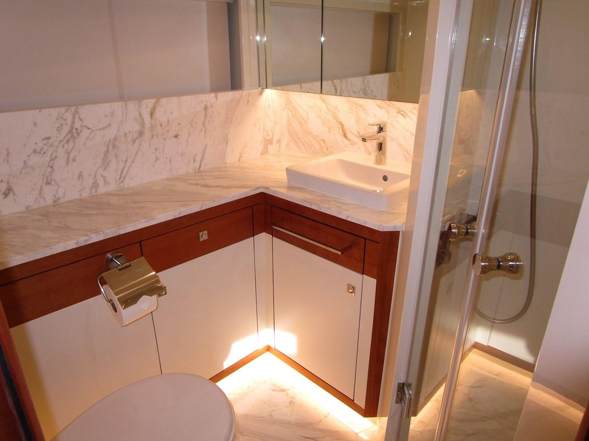 a bathroom with a sink and a shower aboard JOHNSON 83 SKYLOUNGE Yacht for Sale