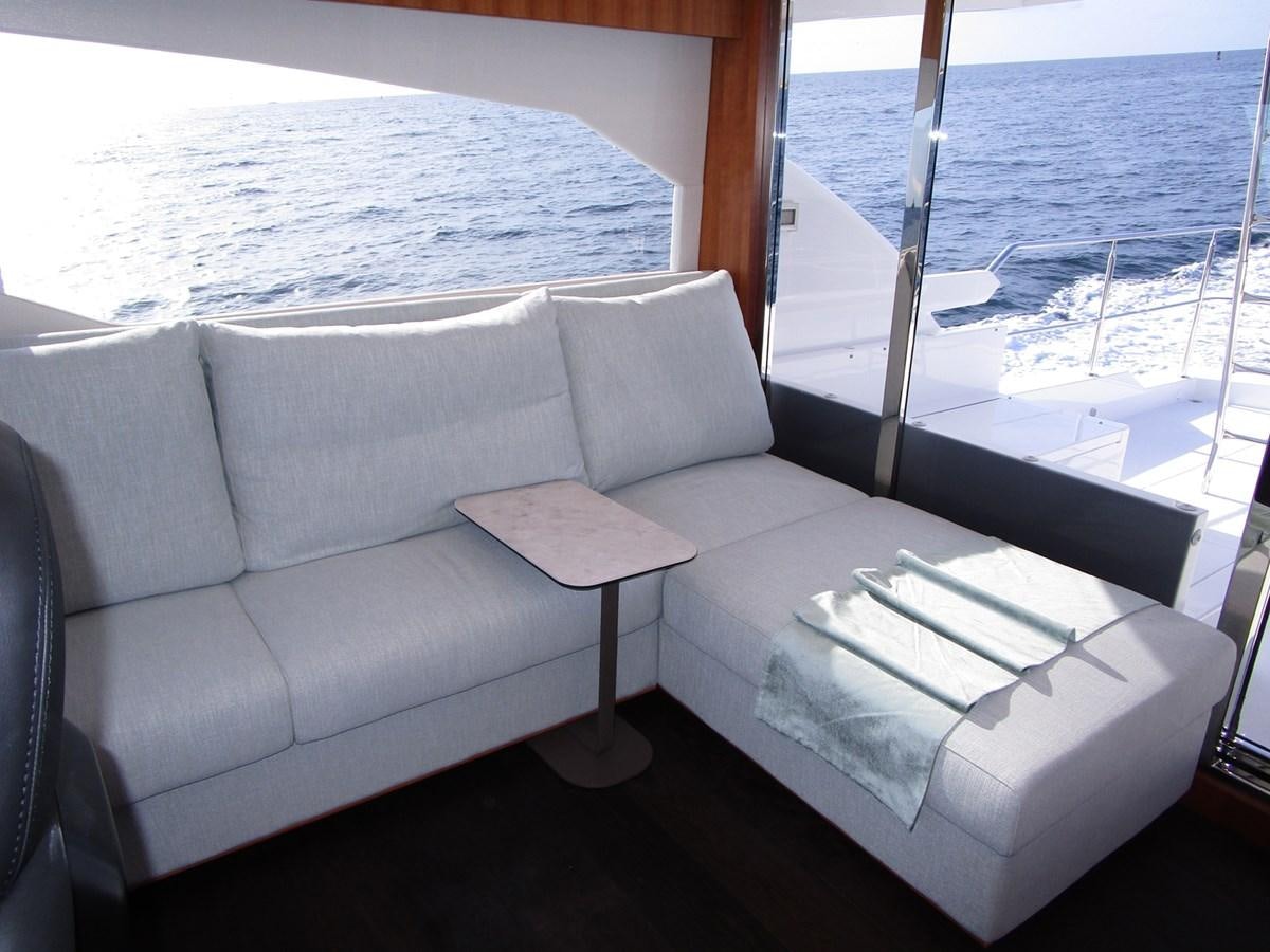 a couch with a table on it aboard JOHNSON 83 SKYLOUNGE Yacht for Sale