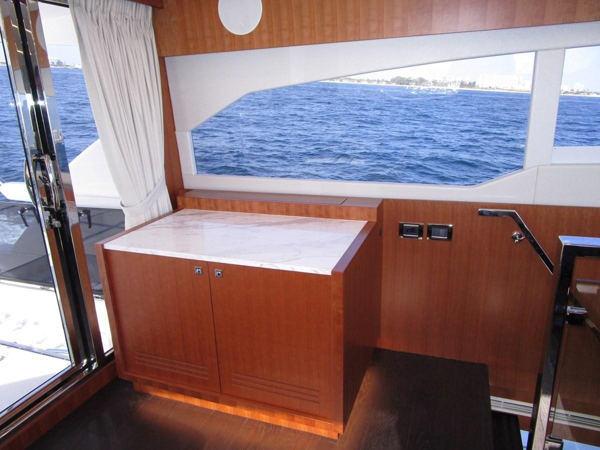 a room with a bed and a window aboard JOHNSON 83 SKYLOUNGE Yacht for Sale