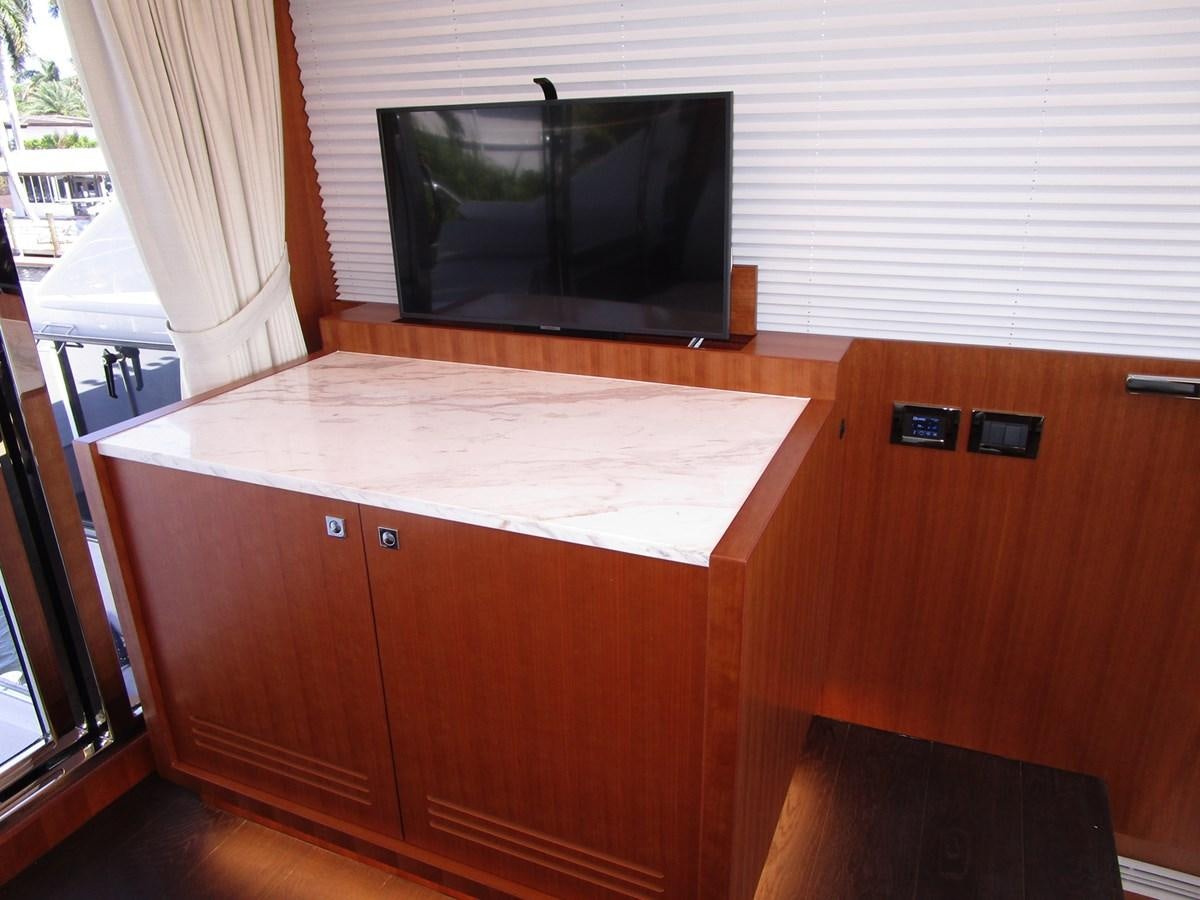 a tv on a counter aboard JOHNSON 83 SKYLOUNGE Yacht for Sale