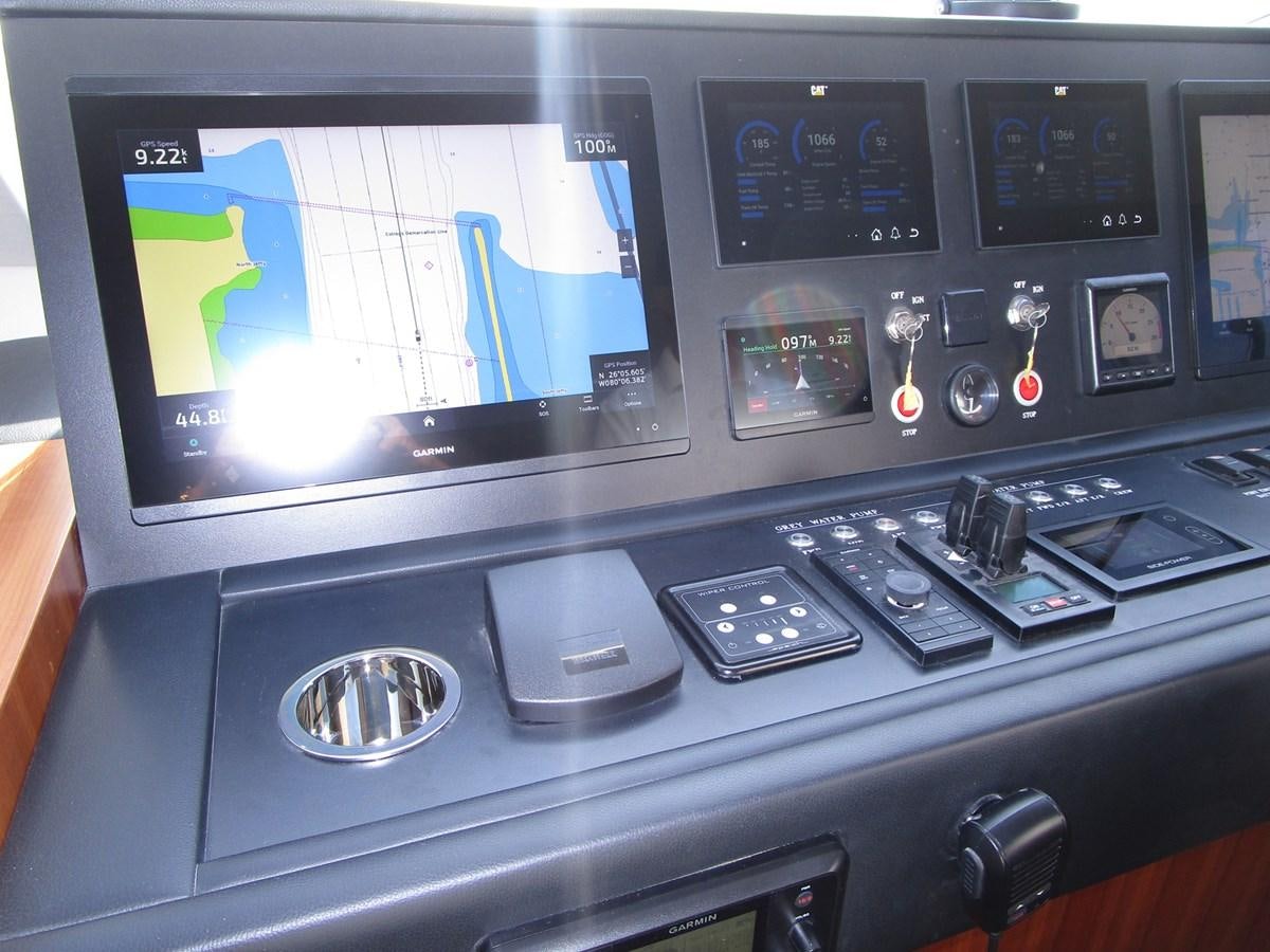 a video game console with a monitor and a keyboard aboard JOHNSON 83 SKYLOUNGE Yacht for Sale