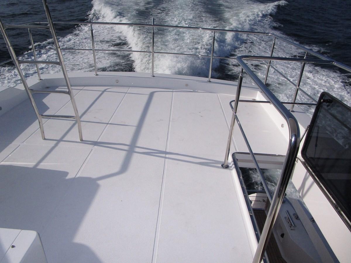 a boat on the water aboard JOHNSON 83 SKYLOUNGE Yacht for Sale