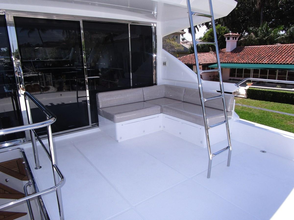 a white deck with a slide aboard JOHNSON 83 SKYLOUNGE Yacht for Sale