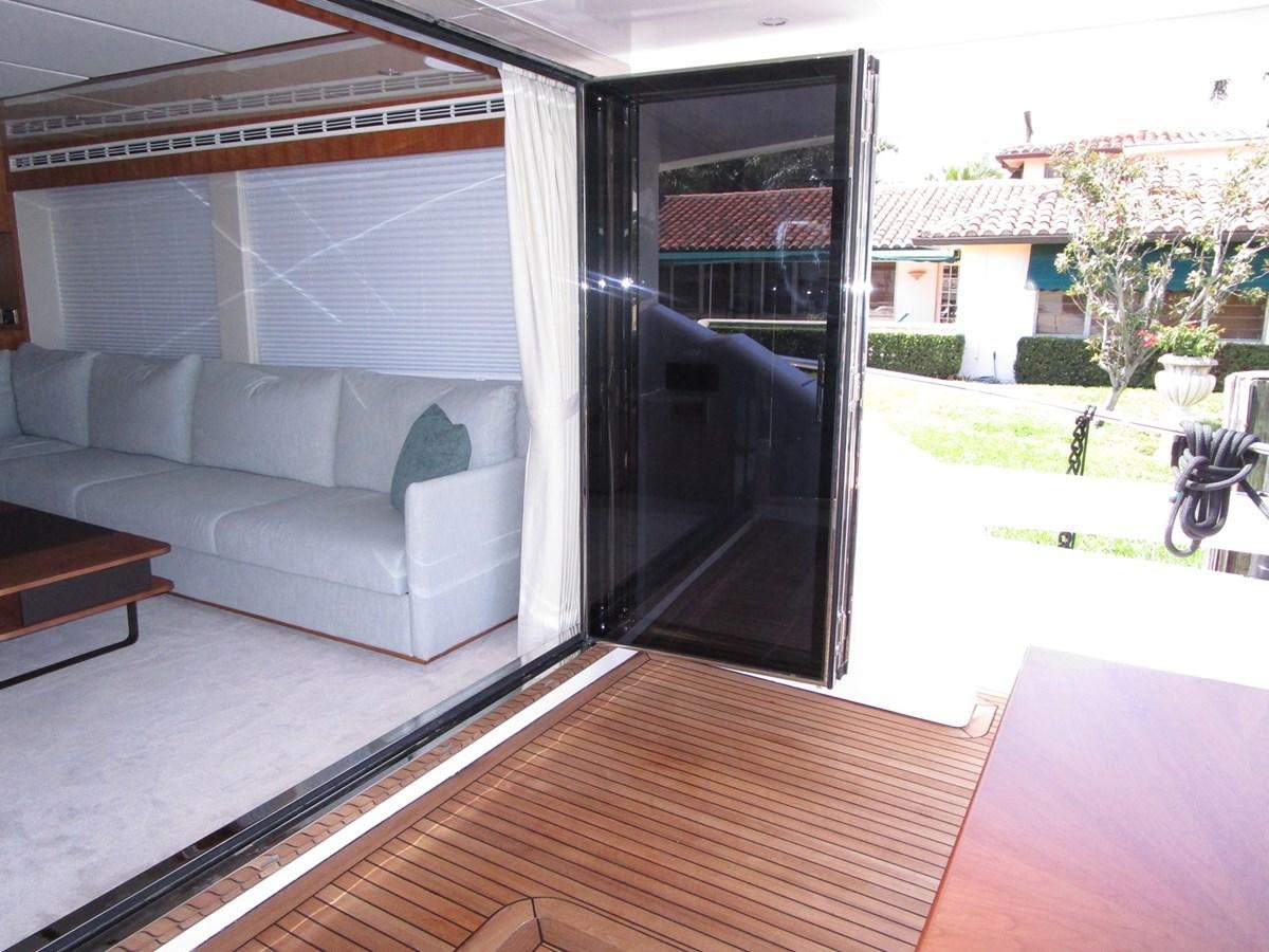 a living room with a patio aboard JOHNSON 83 SKYLOUNGE Yacht for Sale