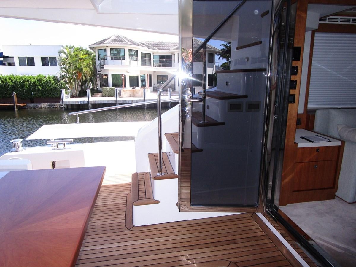 a room with a pool and a deck aboard JOHNSON 83 SKYLOUNGE Yacht for Sale