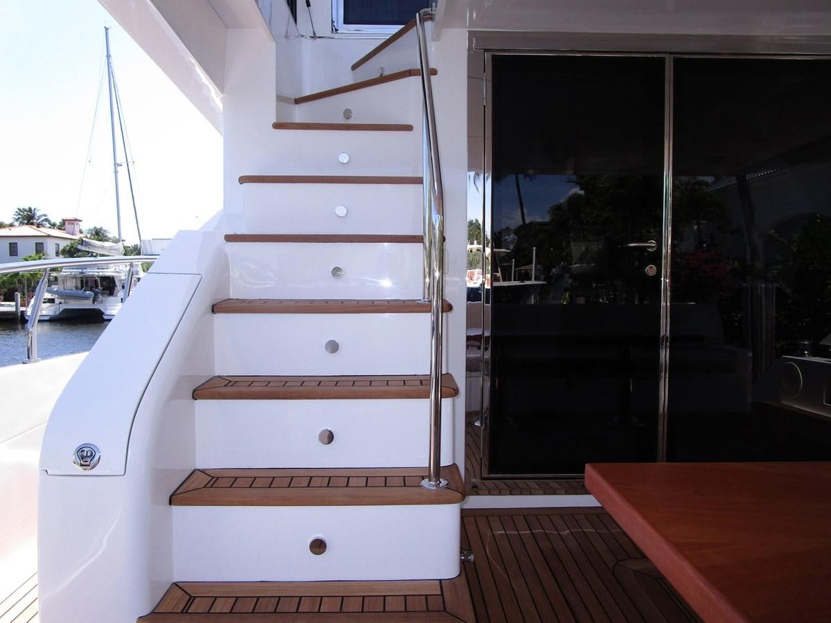 a white wooden staircase aboard JOHNSON 83 SKYLOUNGE Yacht for Sale