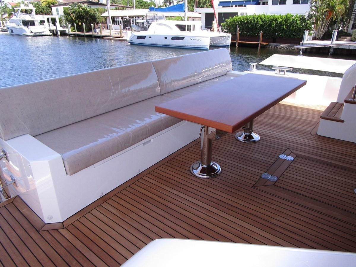 a table on a deck aboard JOHNSON 83 SKYLOUNGE Yacht for Sale