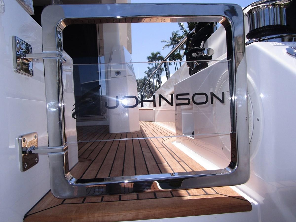 a white boat with black text on it aboard JOHNSON 83 SKYLOUNGE Yacht for Sale