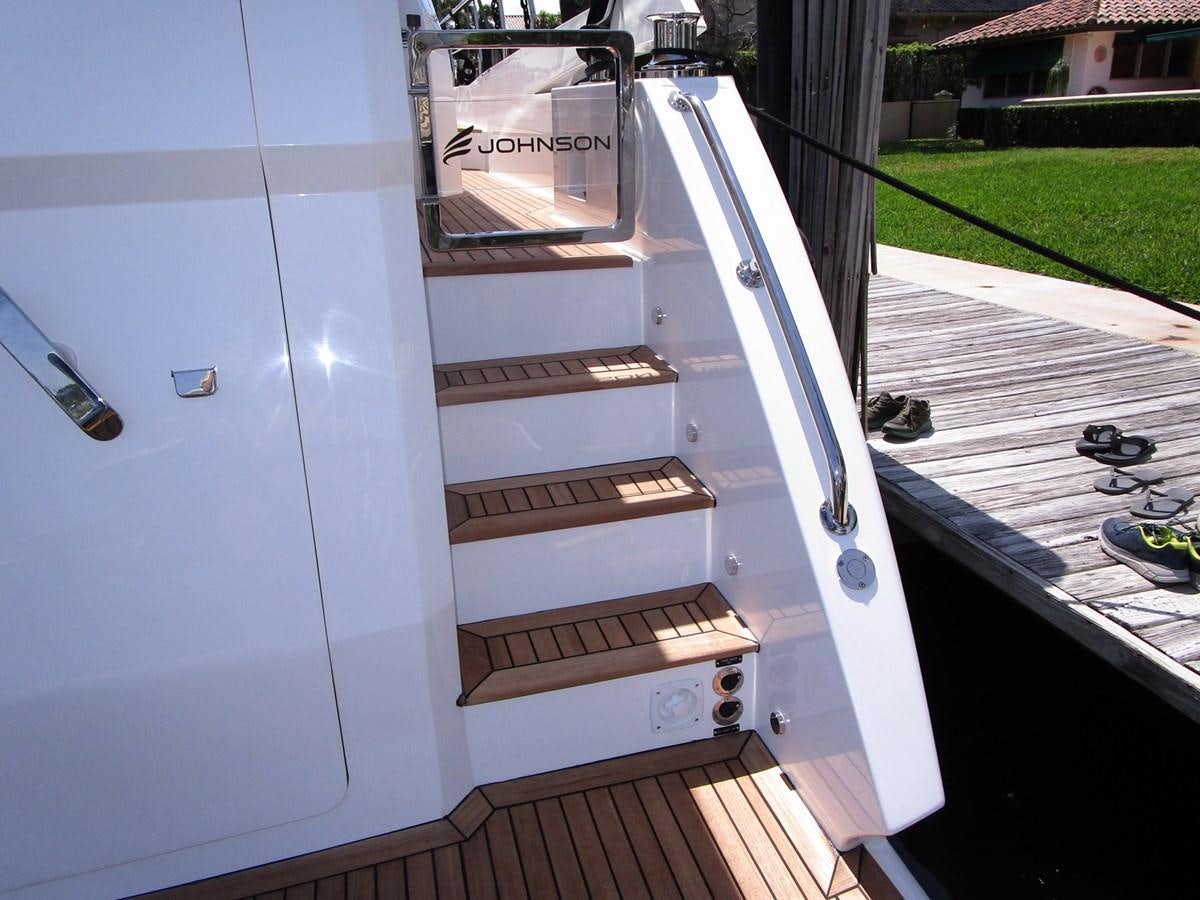 a stack of wood boxes on a deck aboard JOHNSON 83 SKYLOUNGE Yacht for Sale