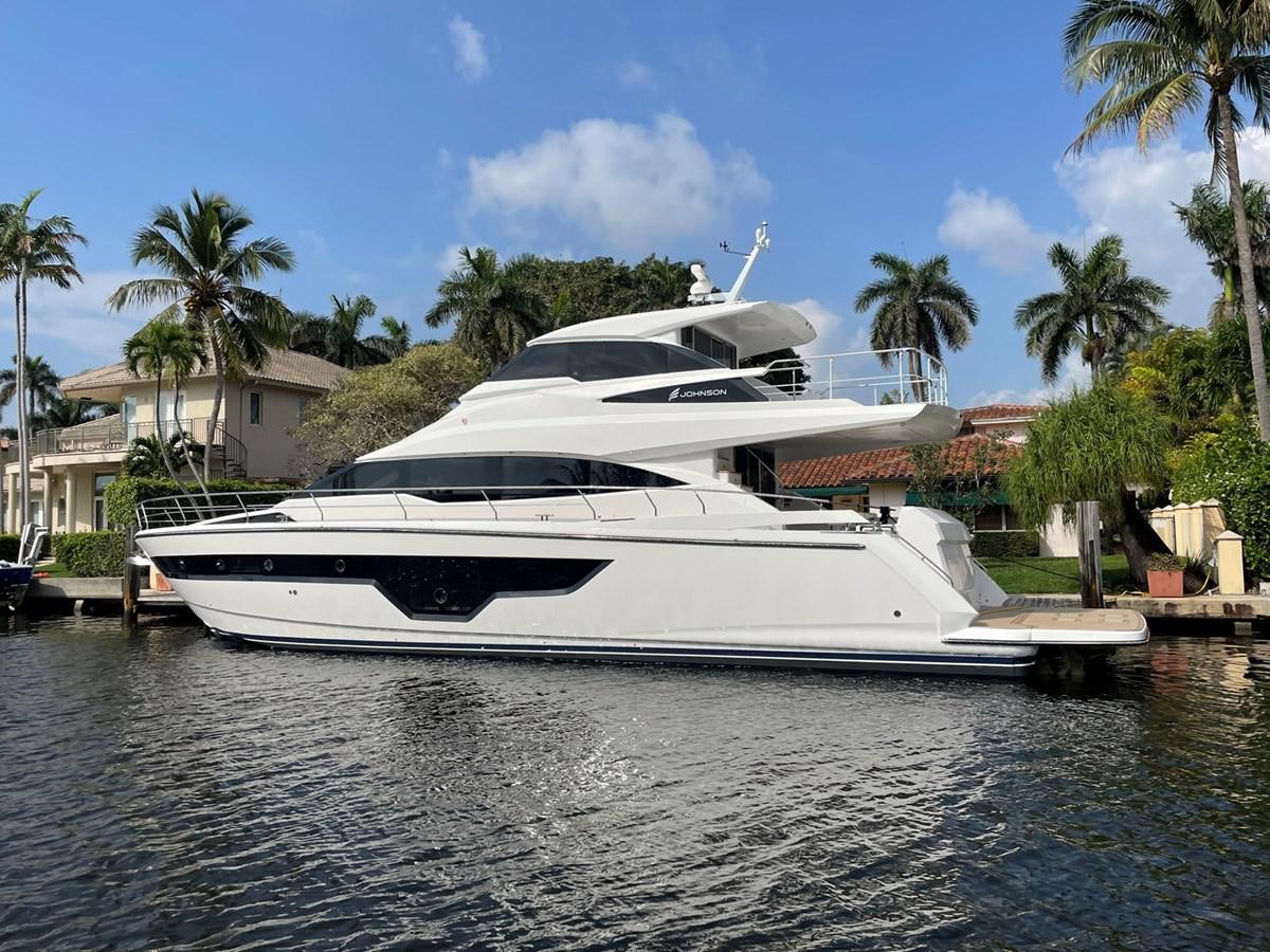 a white boat in a harbor aboard JOHNSON 83 SKYLOUNGE Yacht for Sale