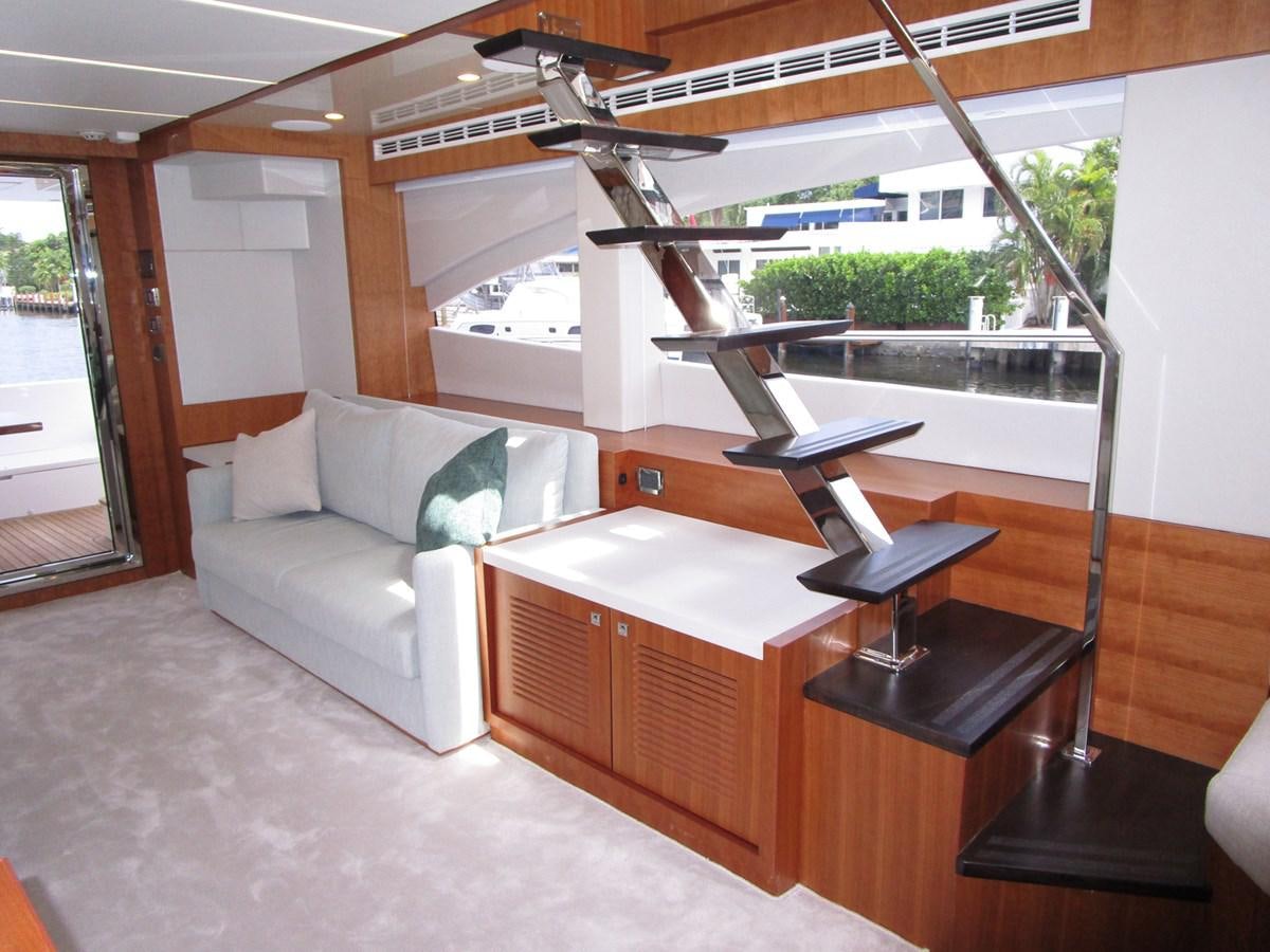 a room with a couch and a laptop on a table aboard JOHNSON 83 SKYLOUNGE Yacht for Sale