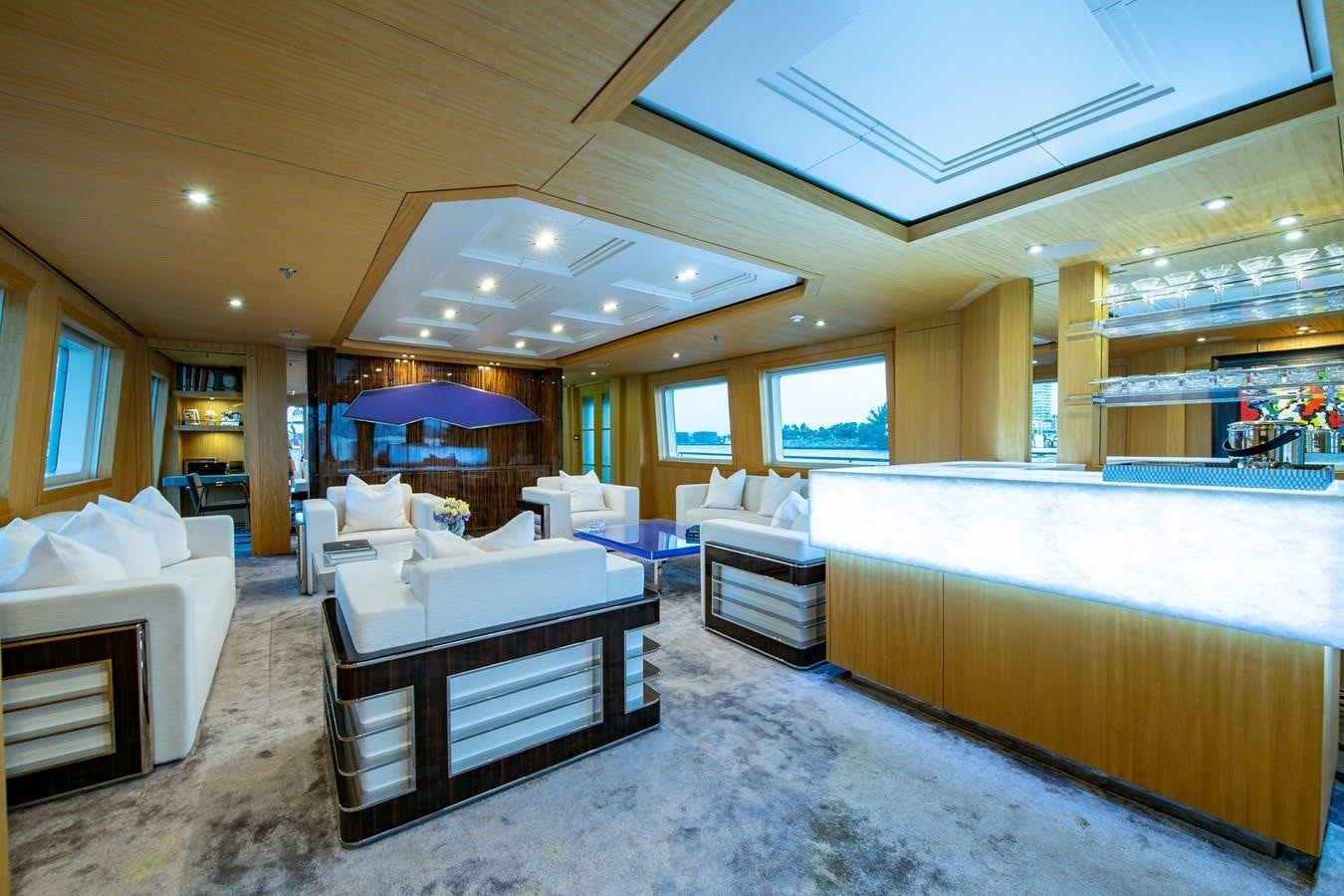 a large room with a bed and a table aboard MIZU Yacht for Sale