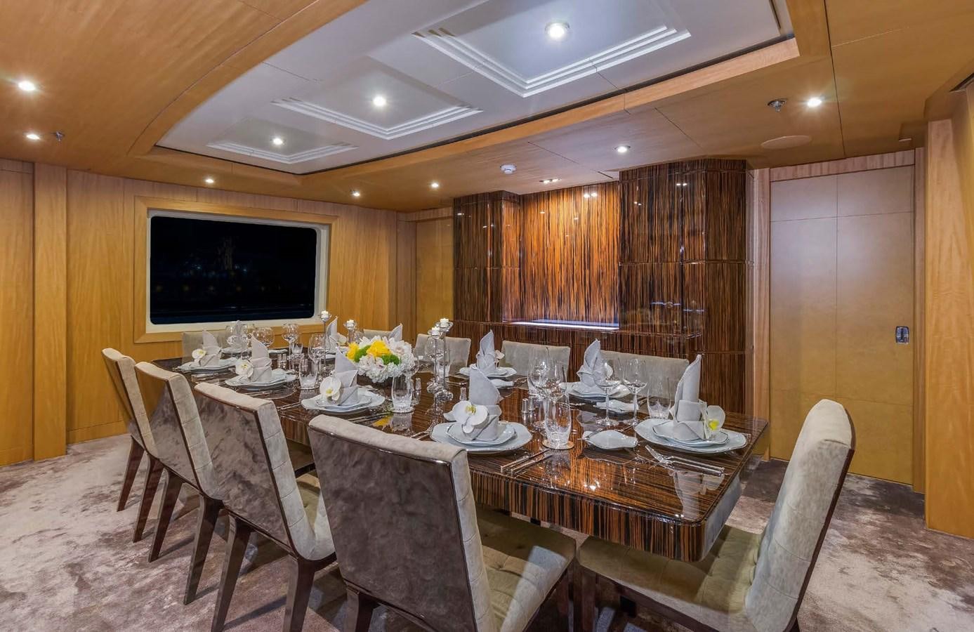 a dining room with a table and chairs aboard MIZU Yacht for Sale