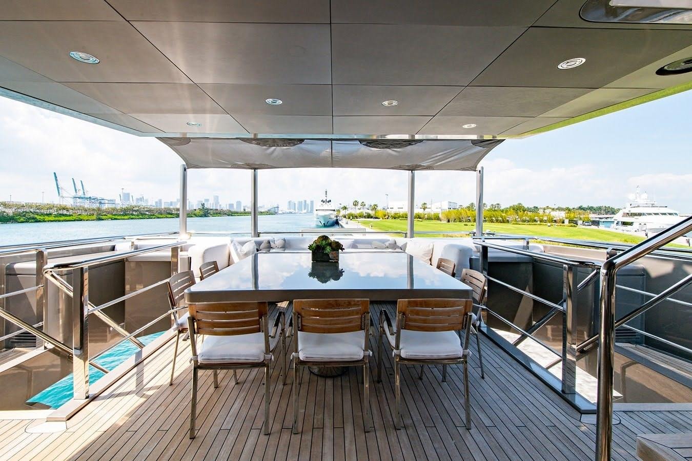 a table and chairs on a deck aboard MIZU Yacht for Sale