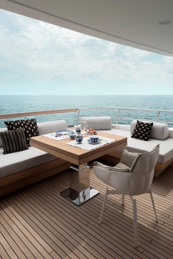 a table and chairs on a deck overlooking the ocean aboard ALEGRIA Y Yacht for Sale