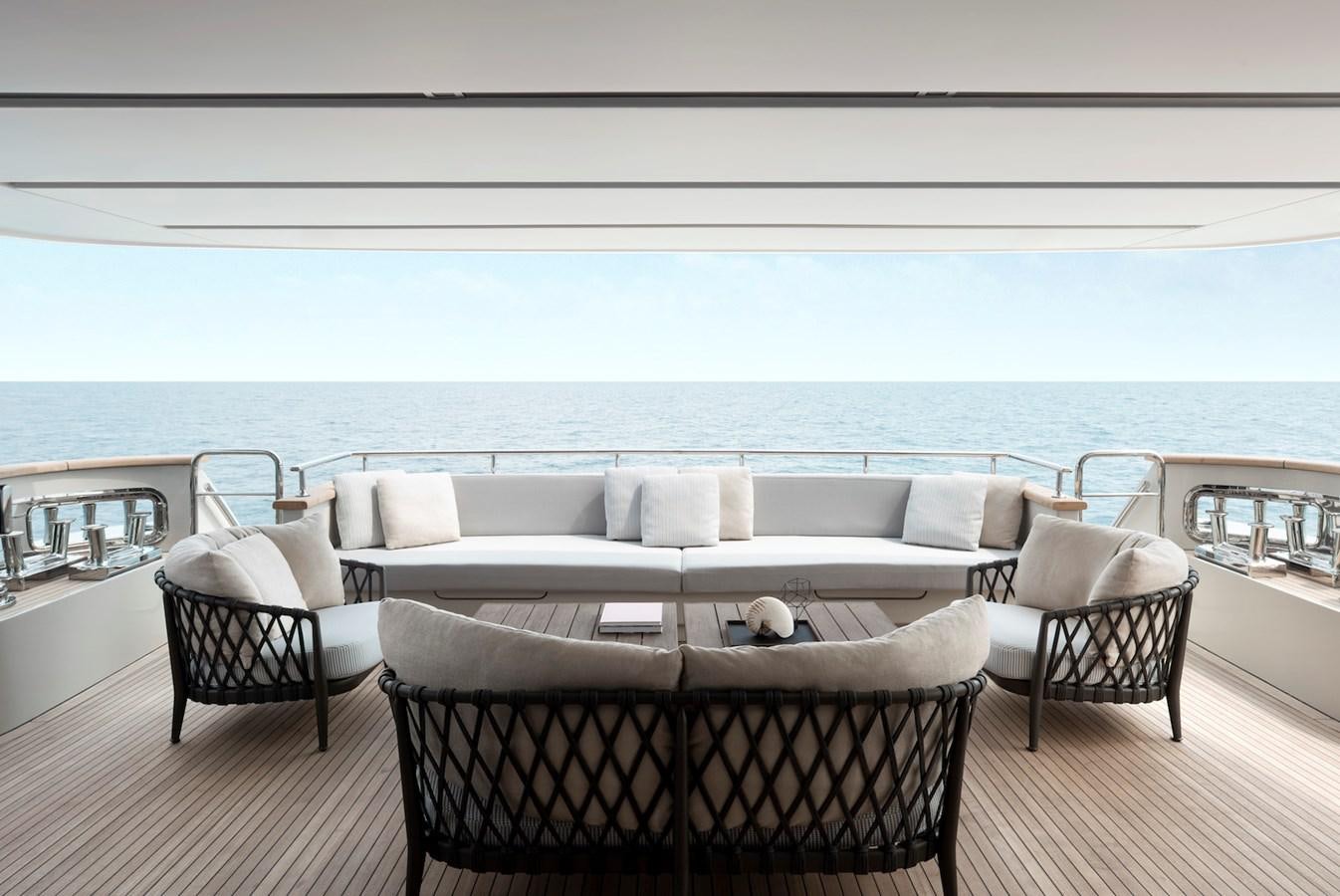 a large white couch and chairs on a deck overlooking the ocean aboard ALEGRIA Y Yacht for Sale