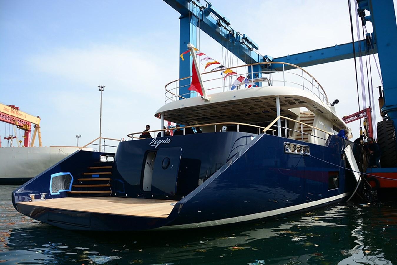 a boat docked at a pier aboard LEGATO Yacht for Sale