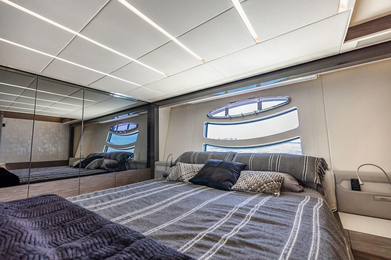 a bed with a blue and white checkered blanket aboard DOUBLE OR NOTHING Yacht for Sale