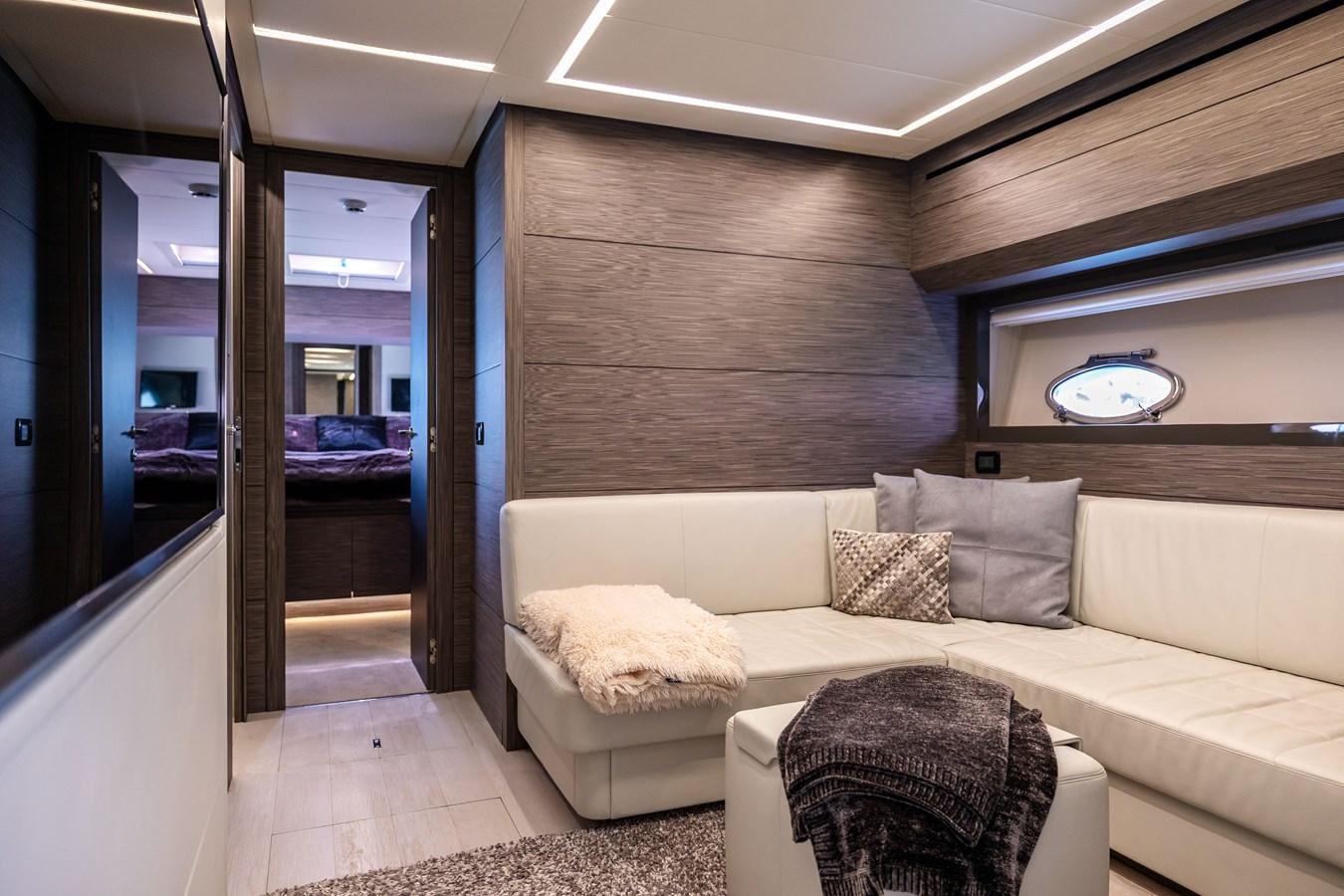 a living room with a couch and a sliding glass door aboard DOUBLE OR NOTHING Yacht for Sale