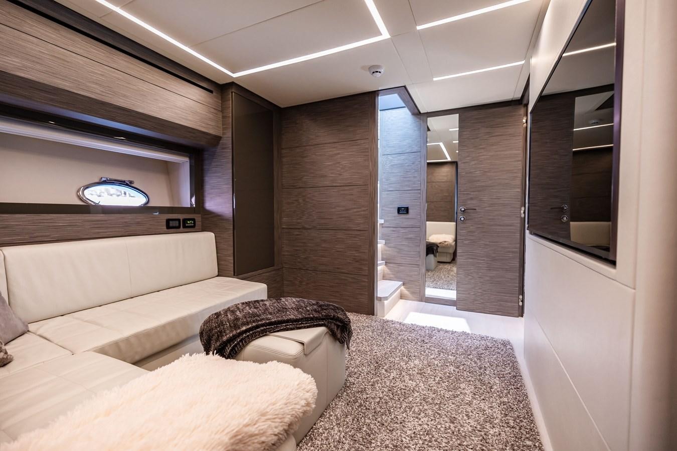 a room with a couch and a tv on the wall aboard DOUBLE OR NOTHING Yacht for Sale