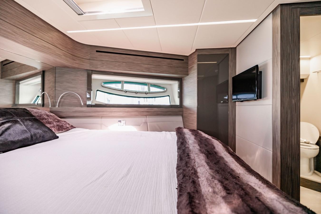 a bedroom with a bed and tv aboard DOUBLE OR NOTHING Yacht for Sale