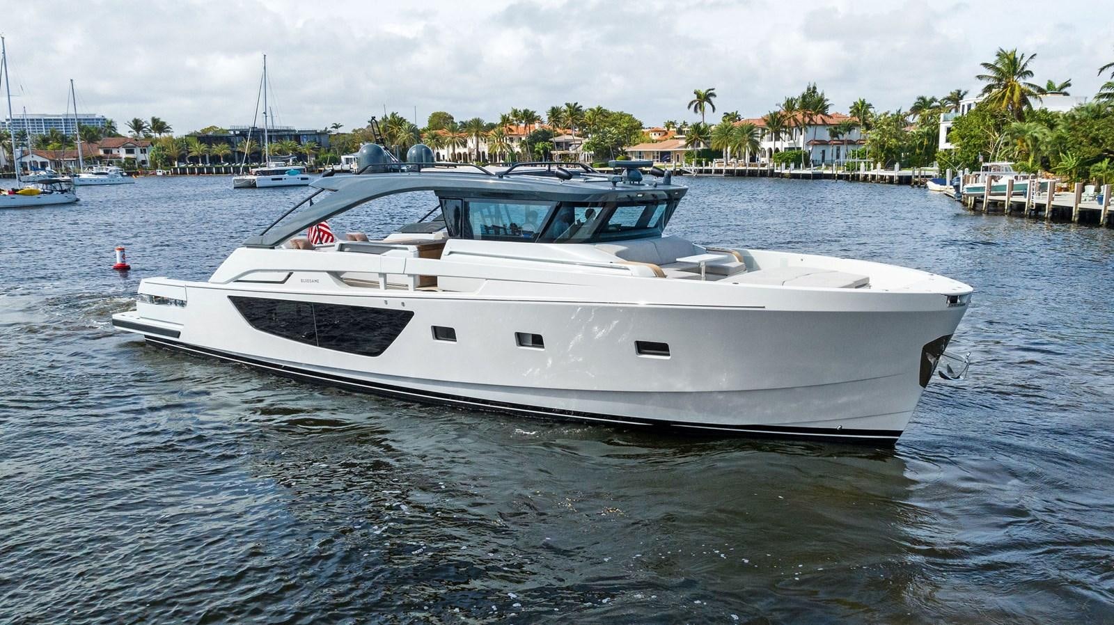 a white boat in the water aboard SNACK MONEY Yacht for Sale