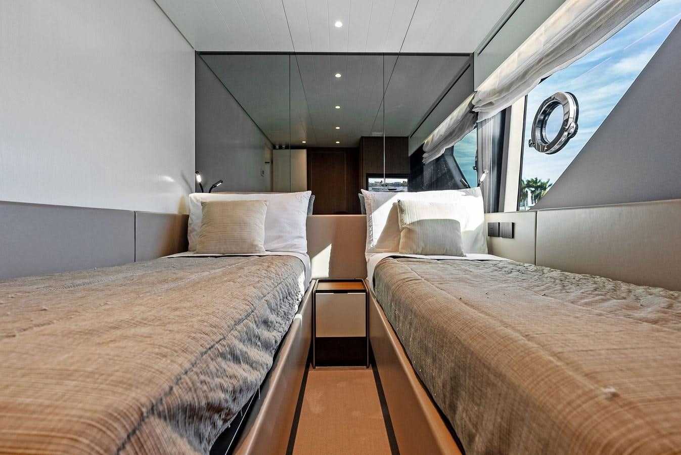 a room with beds and a window aboard SNACK MONEY Yacht for Sale