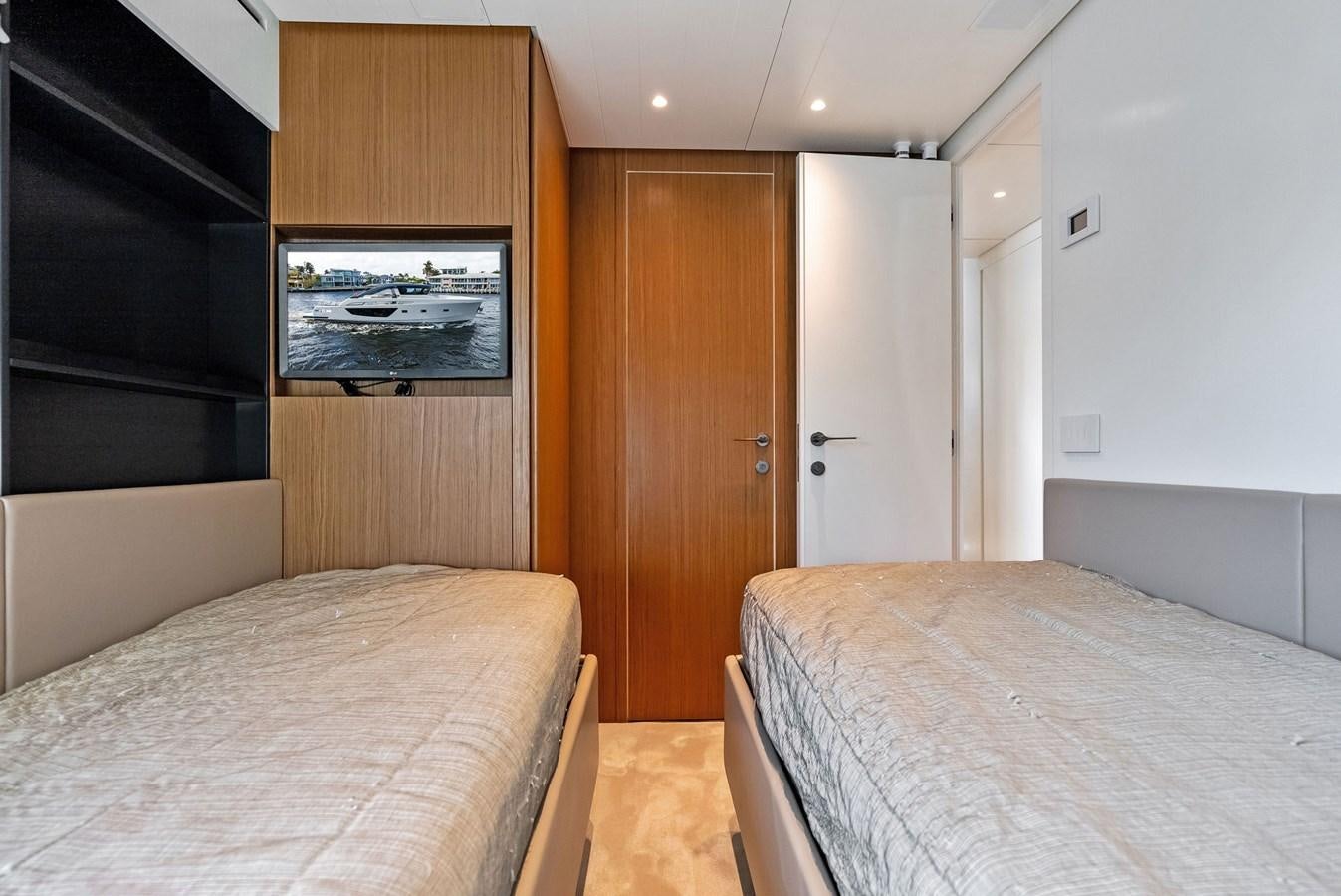 a bedroom with a bed and a television aboard SNACK MONEY Yacht for Sale