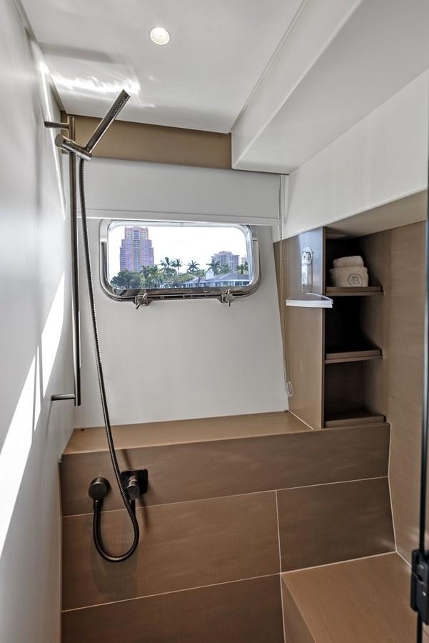 a shower unit with a window aboard SNACK MONEY Yacht for Sale