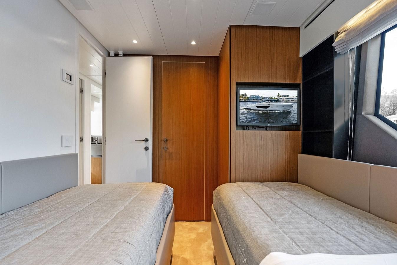 a room with a bed and a television aboard SNACK MONEY Yacht for Sale