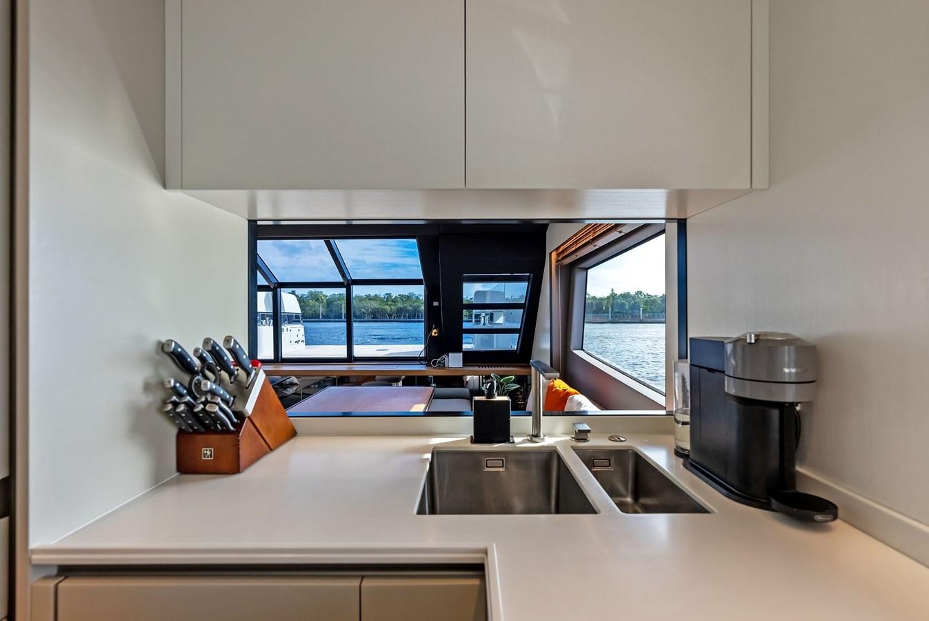 a kitchen with a large window aboard SNACK MONEY Yacht for Sale