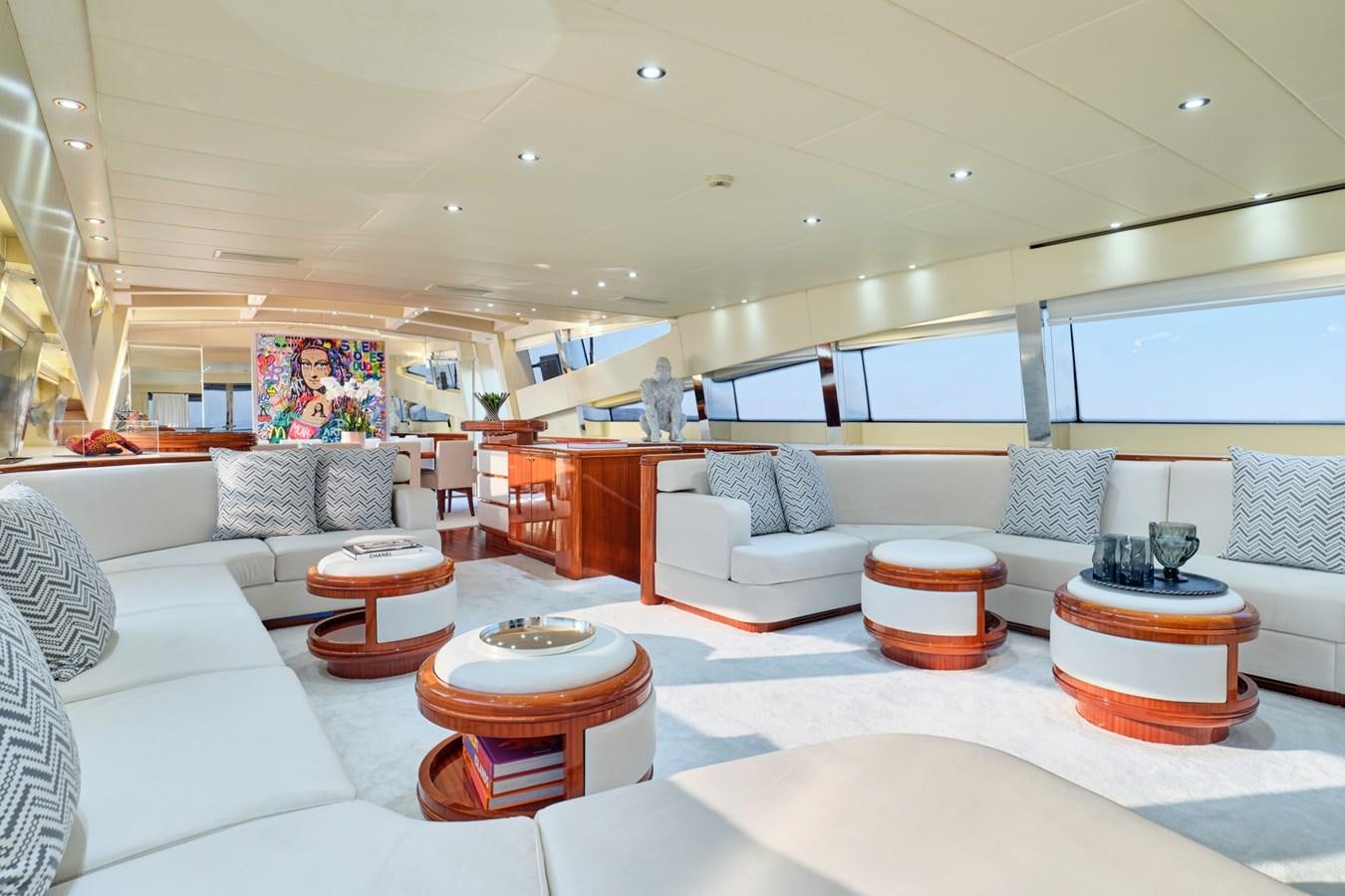 a large living room with a large white sofa and a round table aboard ABILITY Yacht for Sale