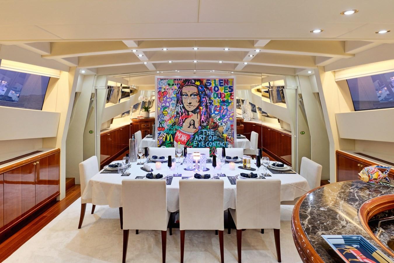 a large room with tables and chairs aboard ABILITY Yacht for Sale
