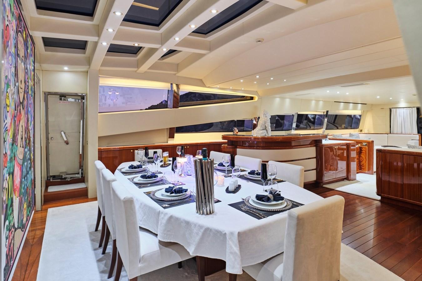 a dining room with a table set aboard ABILITY Yacht for Sale