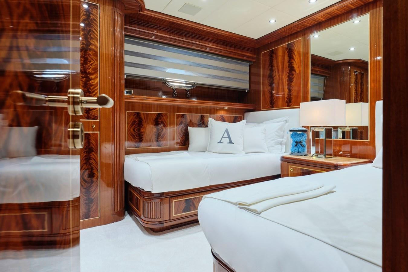 a room with a bed and a mirror aboard ABILITY Yacht for Sale