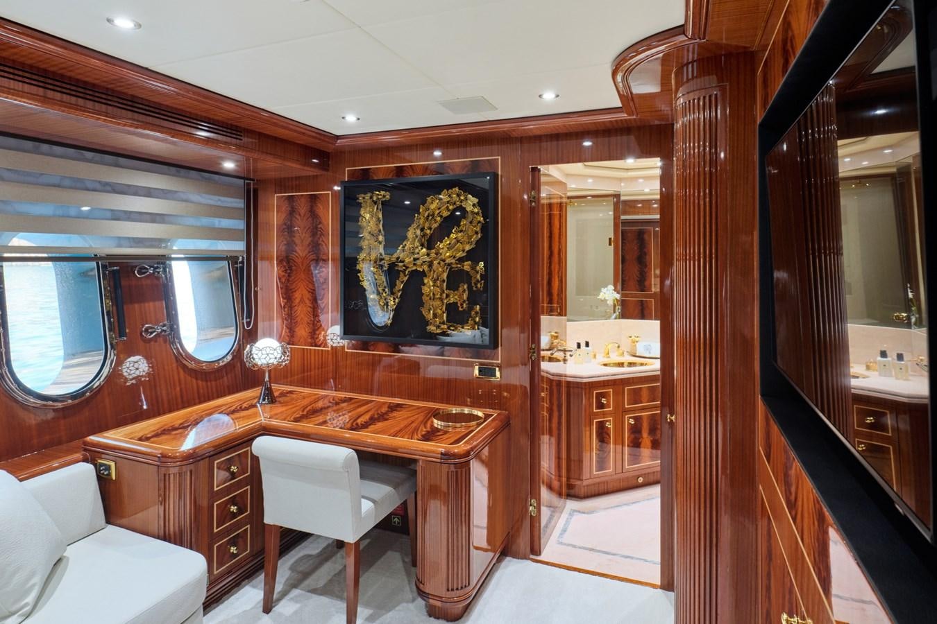 a room with a desk and chairs aboard ABILITY Yacht for Sale