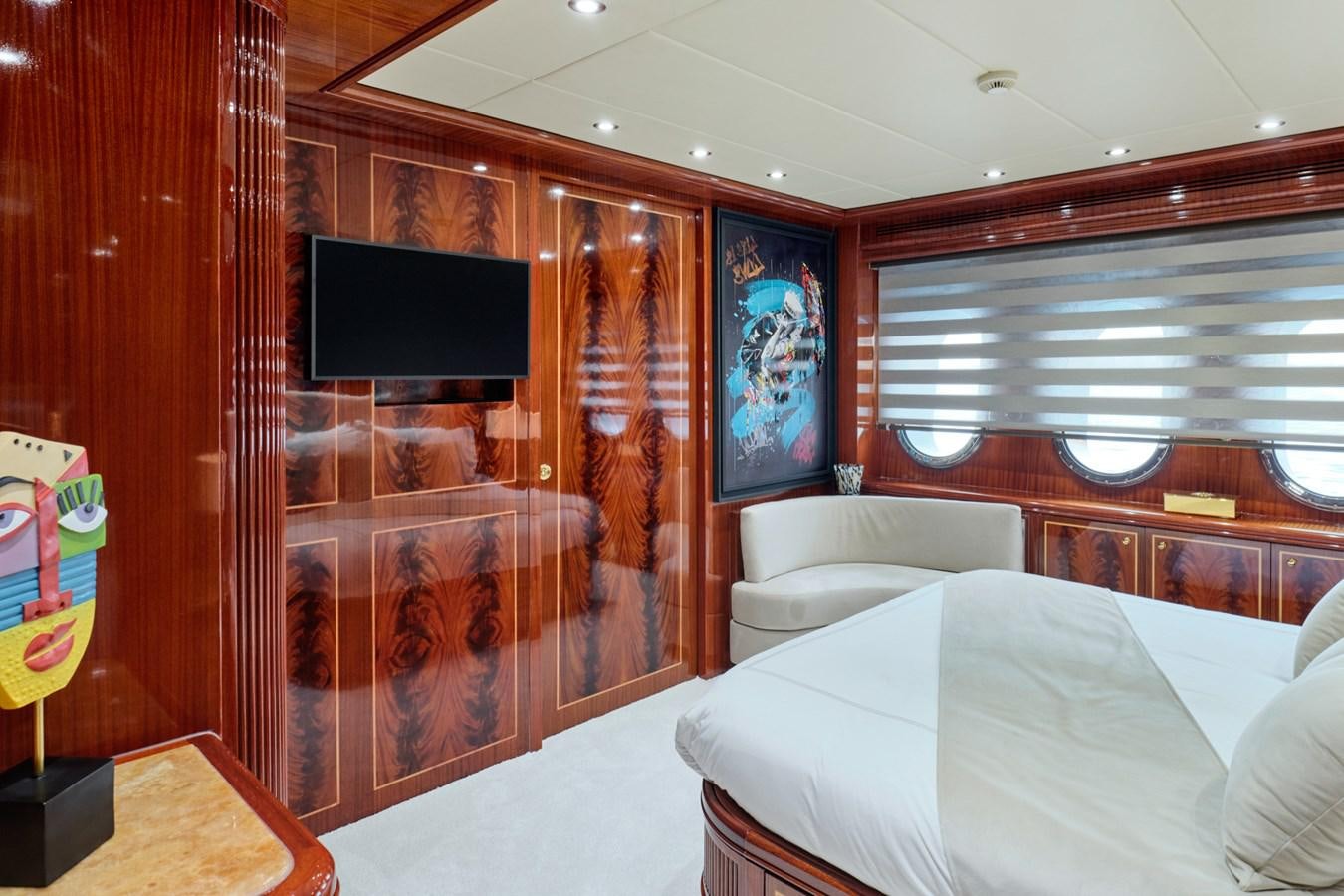 a room with a tv and couch aboard ABILITY Yacht for Sale