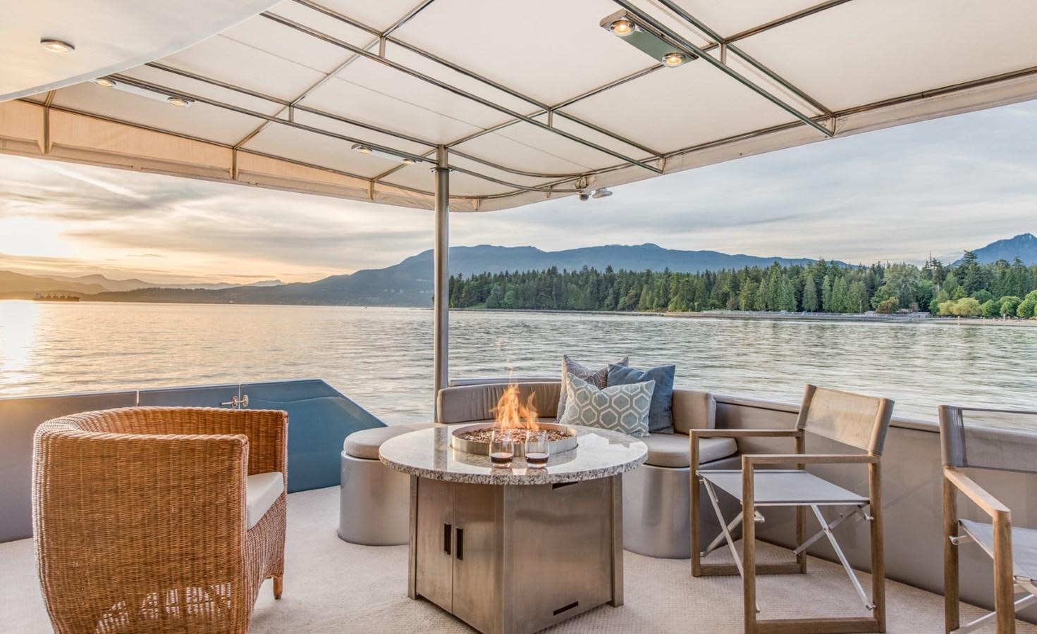 a table and chairs on a patio aboard ASCENTE Yacht for Sale