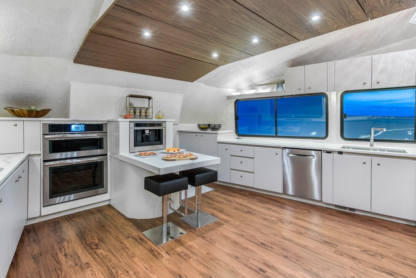 a kitchen with white cabinets aboard ASCENTE Yacht for Sale