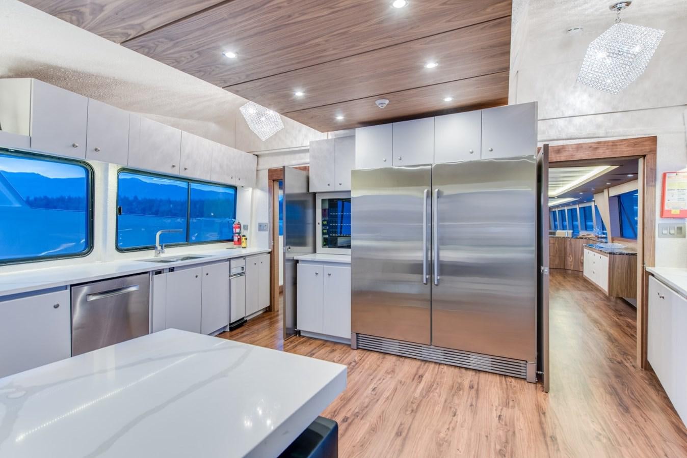 a kitchen with a large refrigerator aboard ASCENTE Yacht for Sale