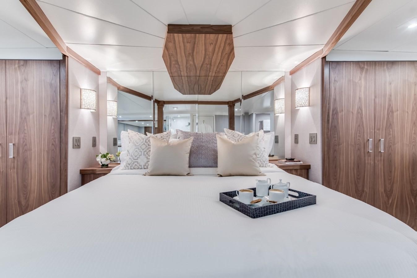 a bed with white sheets and pillows aboard ASCENTE Yacht for Sale