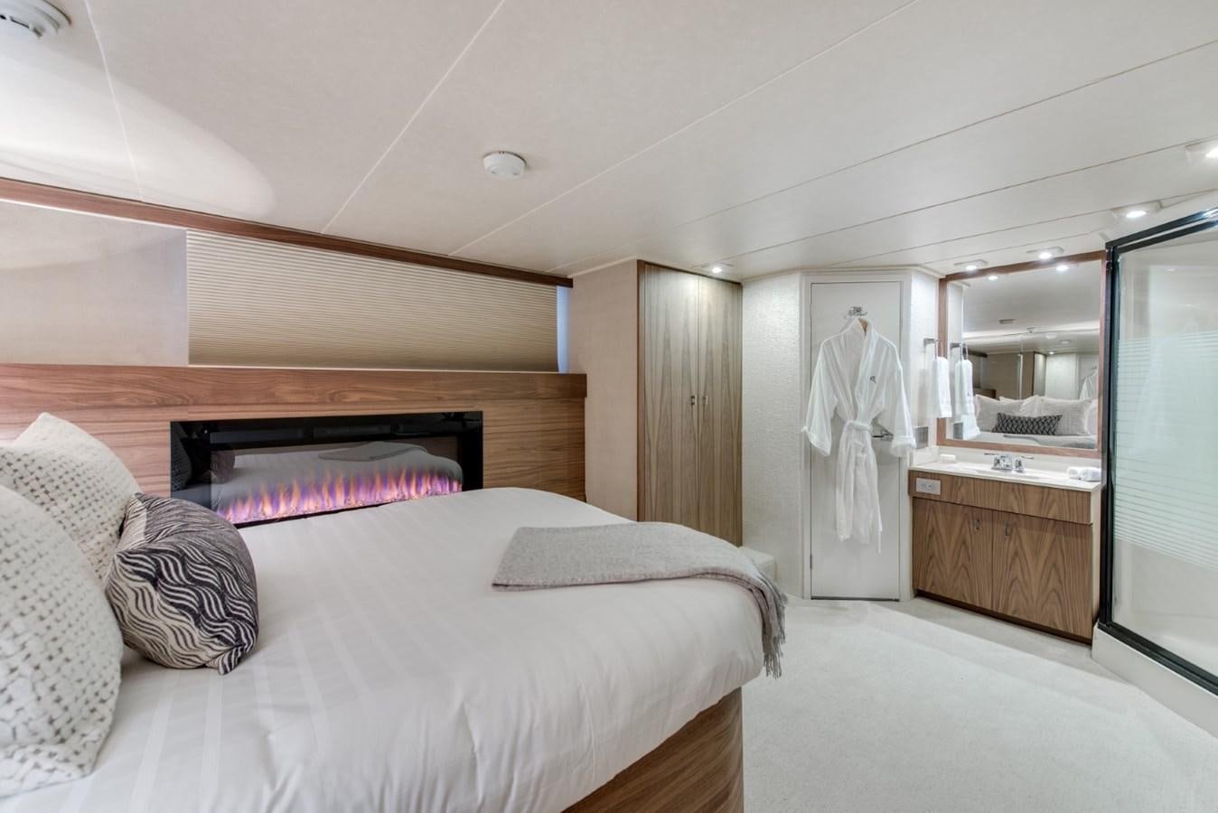 a bedroom with a bed and a mirror aboard ASCENTE Yacht for Sale