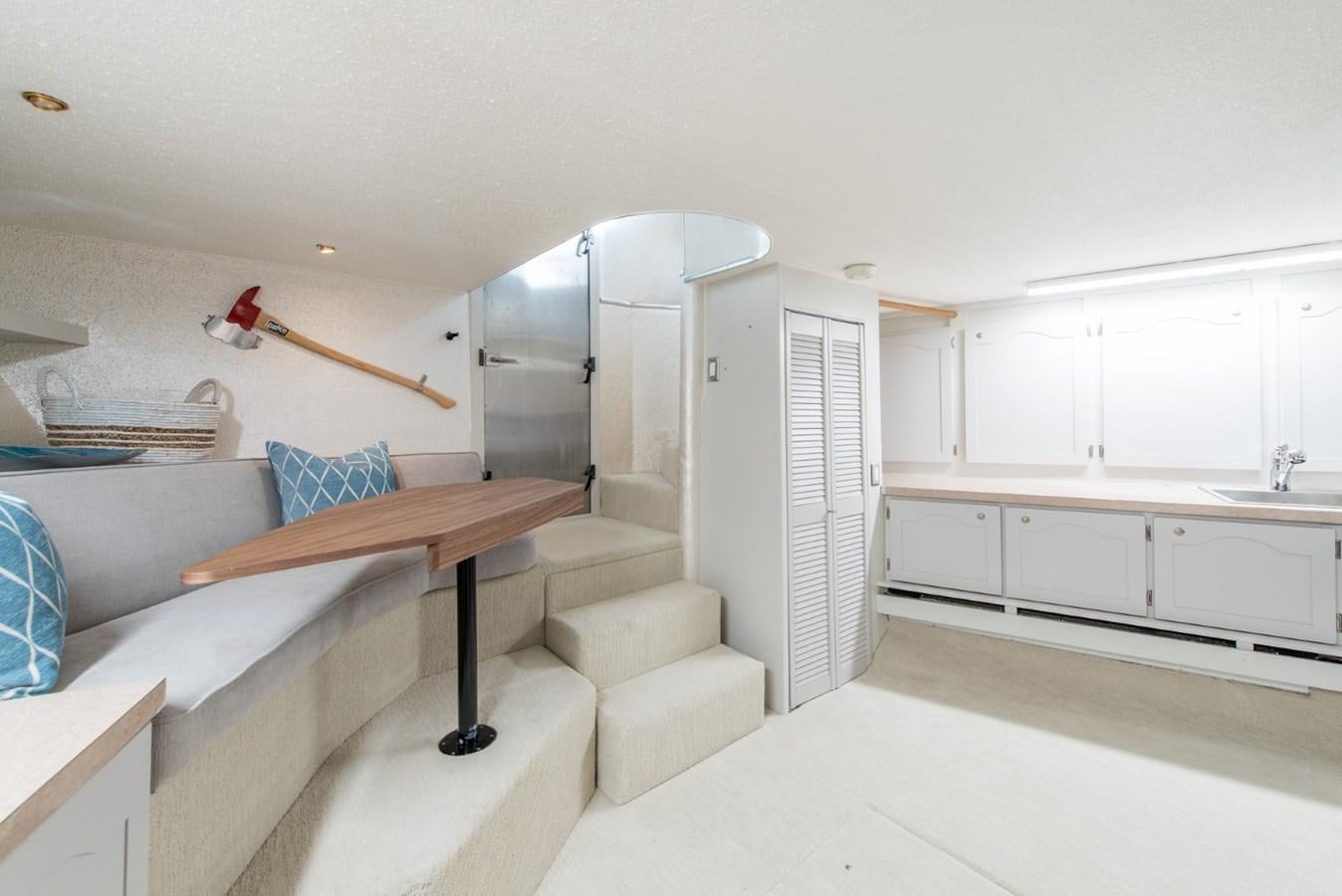 a room with a bed and a table aboard ASCENTE Yacht for Sale