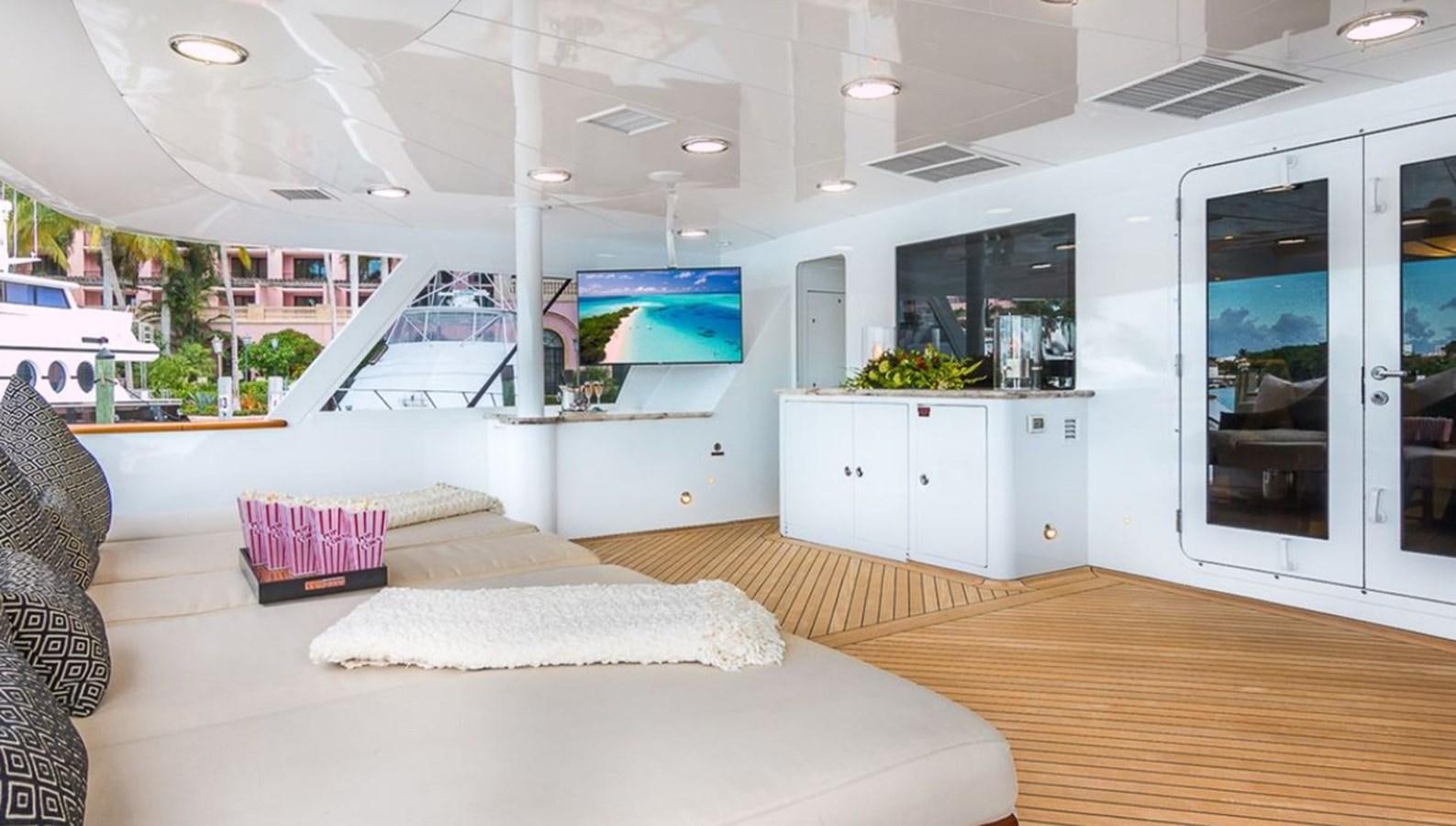 a room with a bed and a desk aboard TRUE LOVE Yacht for Sale