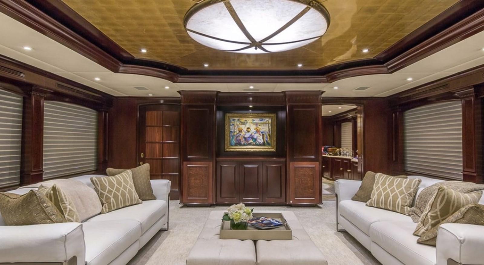 a living room with a large wood cabinet and white couches aboard TRUE LOVE Yacht for Sale