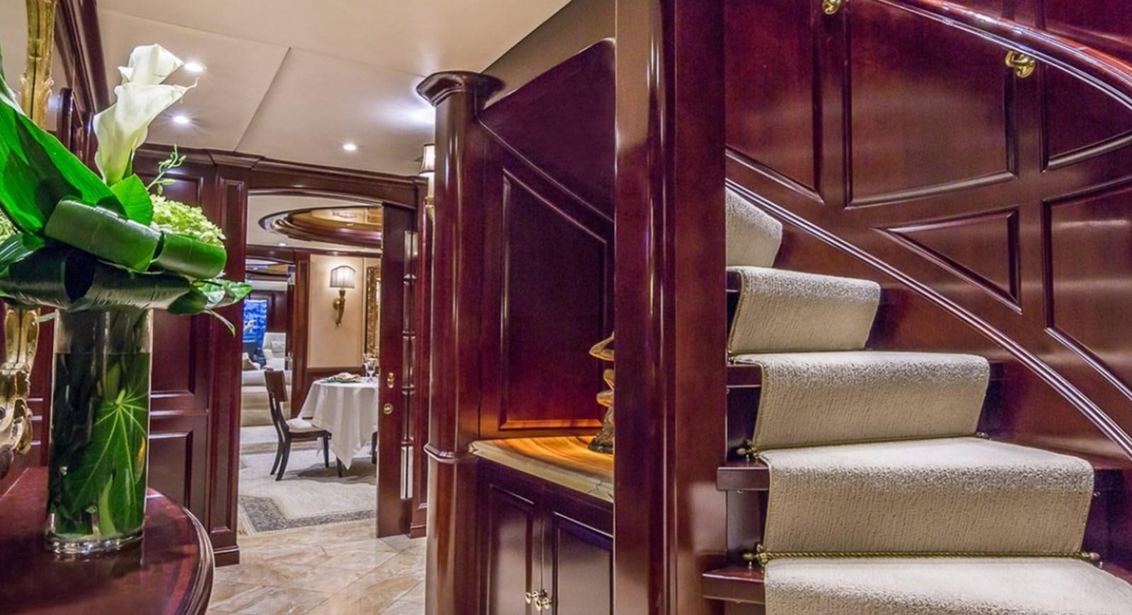 a room with a couch and a vase with flowers aboard TRUE LOVE Yacht for Sale