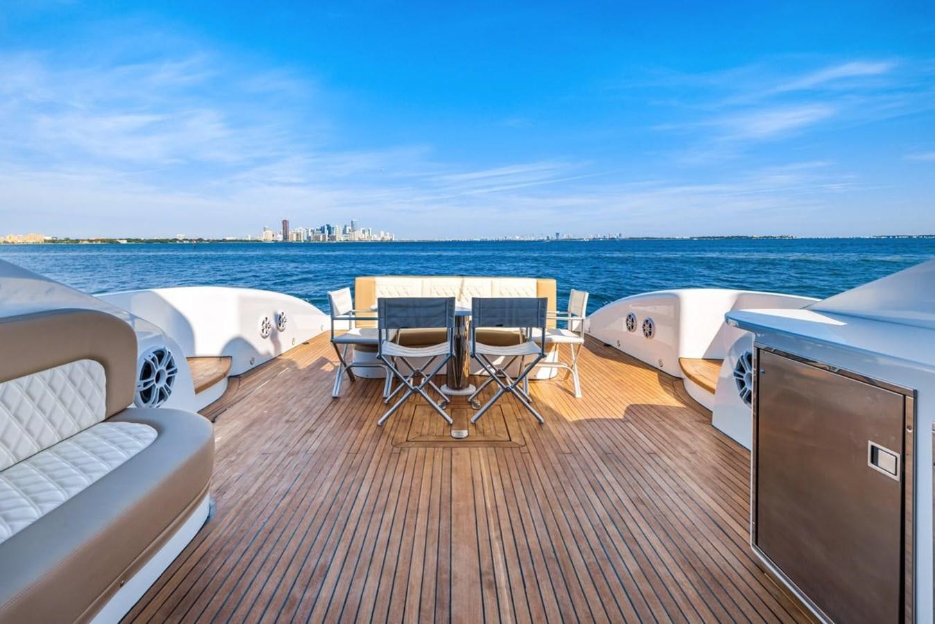 a deck with chairs and tables on it aboard DREAM ON Yacht for Sale